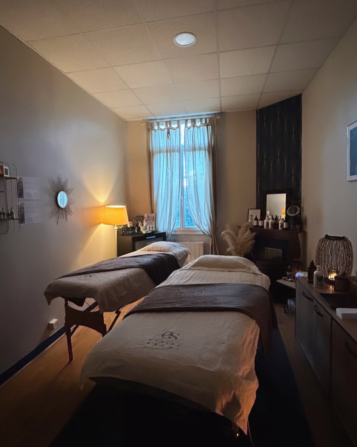 Deux personnes allongées côte à côte dans une cabine de massage, ambiance polynésienne.